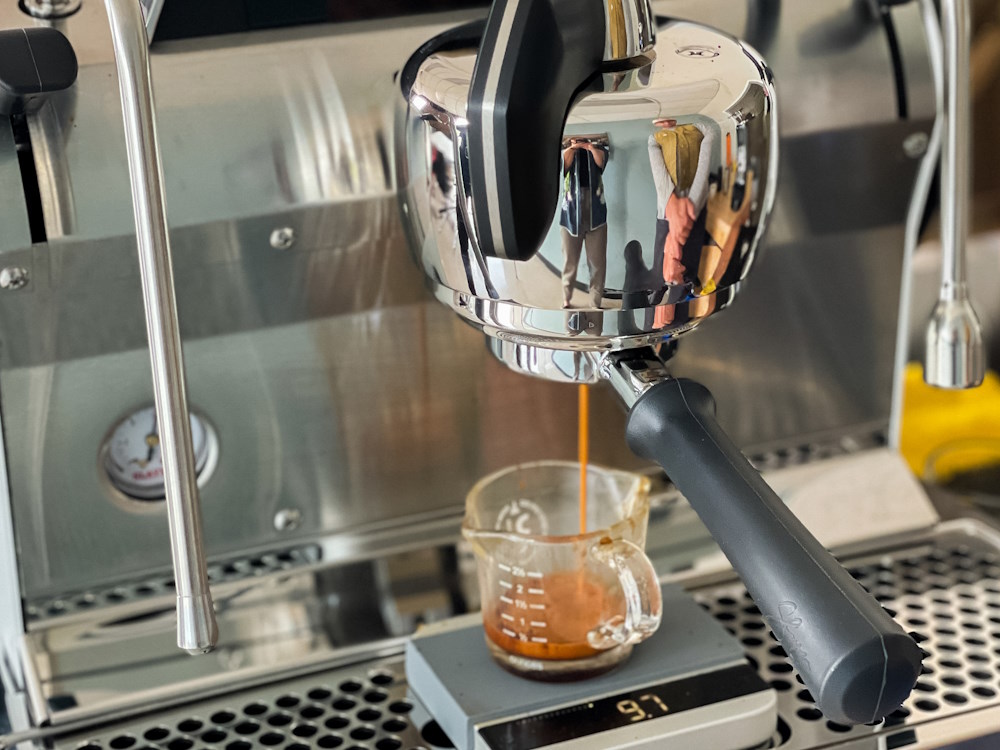 A double espresso being extracted into jug using a Slayer prosumer machine.
