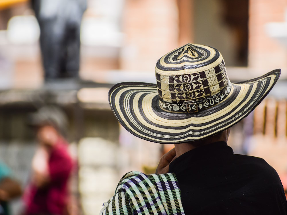 A person wearing a patterned hat in Colombia.