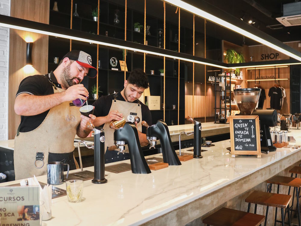 Baristas prepare drinks using a Modbar espresso machine.
