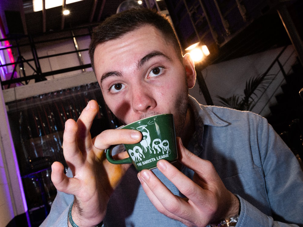 An attendee drinks coffee at the 2024 Barista League Barcelona event.