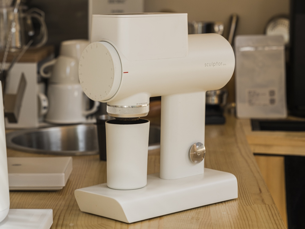 A white Timemore Sculptor grinder in a kitchen.