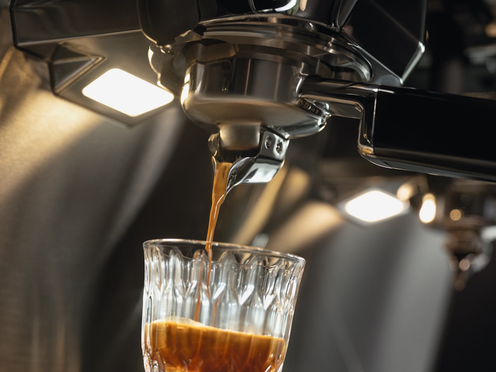 A close up of espresso extraction on the WMF semi automatic portafilter machine.