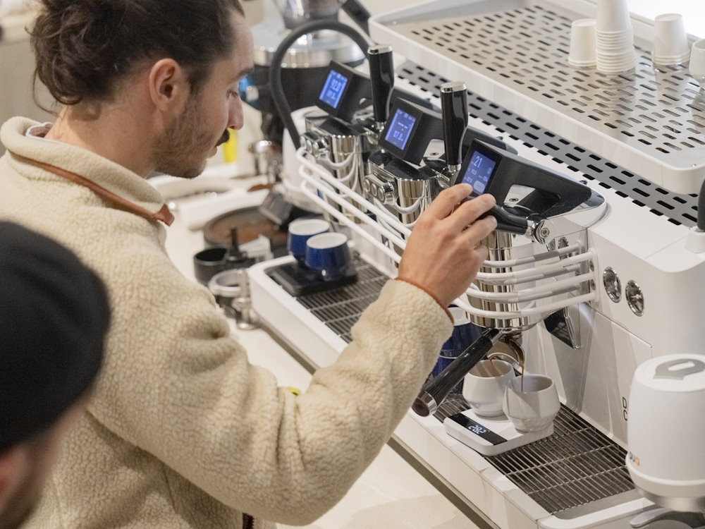 A barista uses a Dalla Corte espresso machine.
