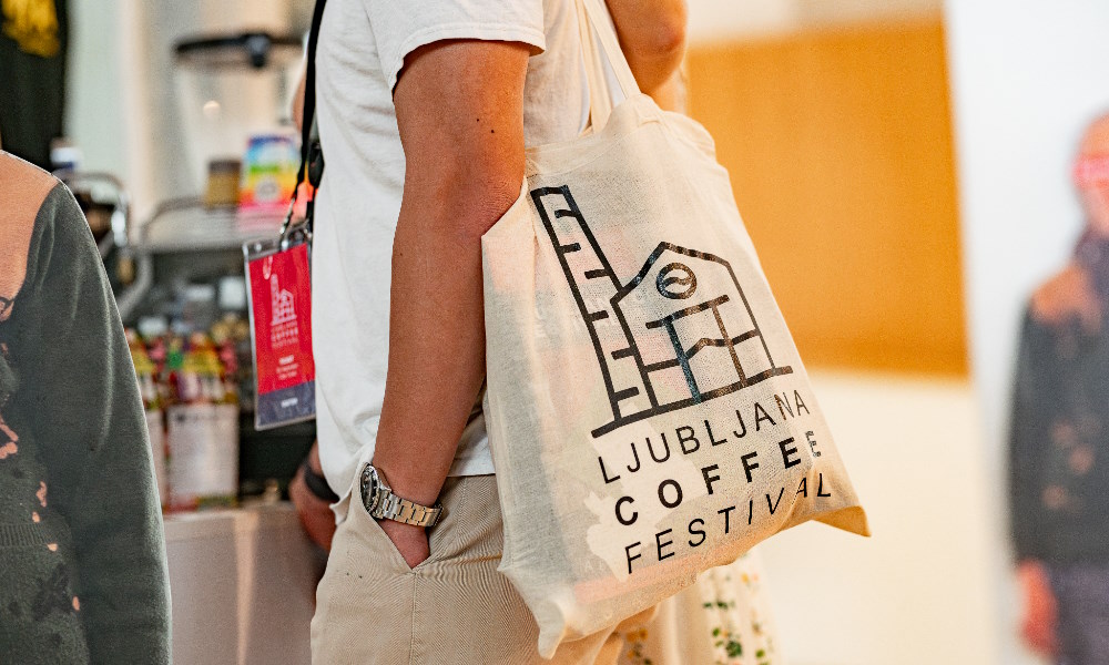 A Ljubljana Coffee Festival attendee carries an event tote bag.
