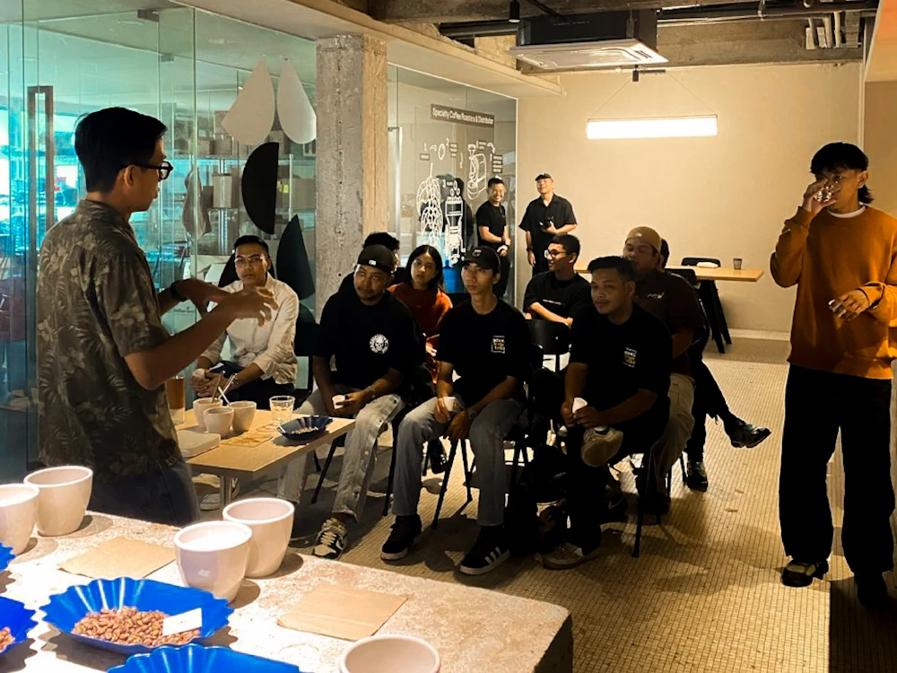 A group of people attend a coffee class at CC:Roasters in Malaysia.